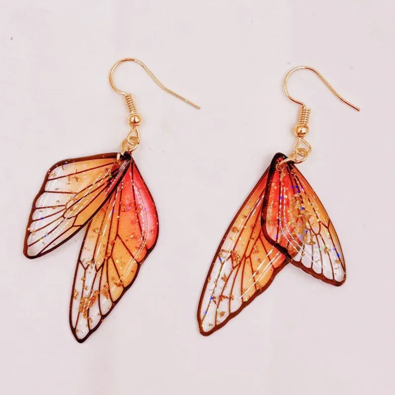 Boucles d'oreilles résine ailes dégradées strass papillon